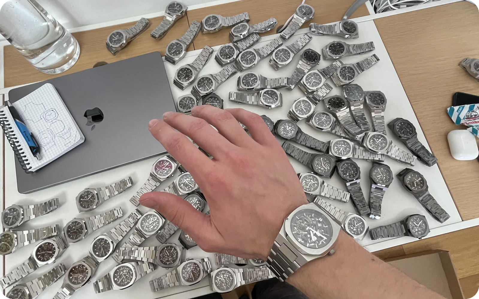 A desk covered in Twofourtyseven S.9.4 watches, one on my wrist